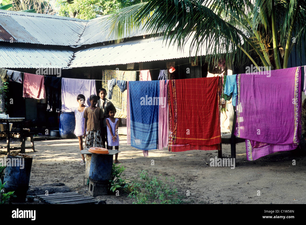 Children standing near drying sarees, Havelock Island, Andaman Islands, Andaman and Nicobar