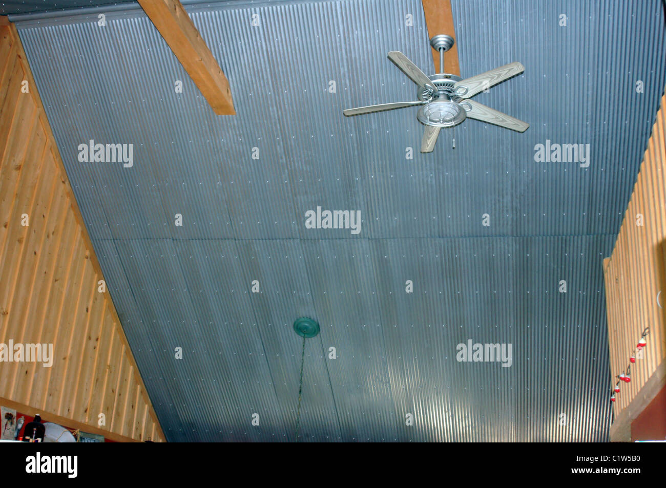 Photo of a corrugated tin ceiling and ceiling fan in a river cabin in Arkansas Stock Photo