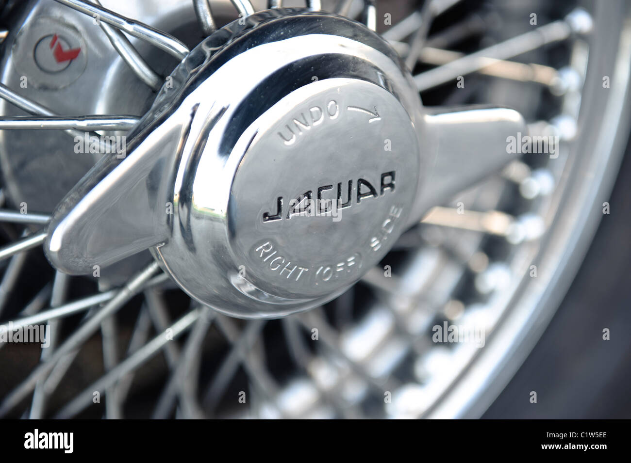 Jaguar E-Type chrome front wheel spokes close up detail Stock Photo