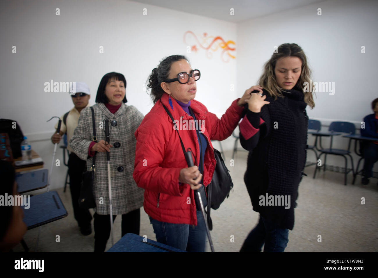 Gina Badenoch guides blind students during a photography workshop for the blind and visually impaired in Mexico City Stock Photo
