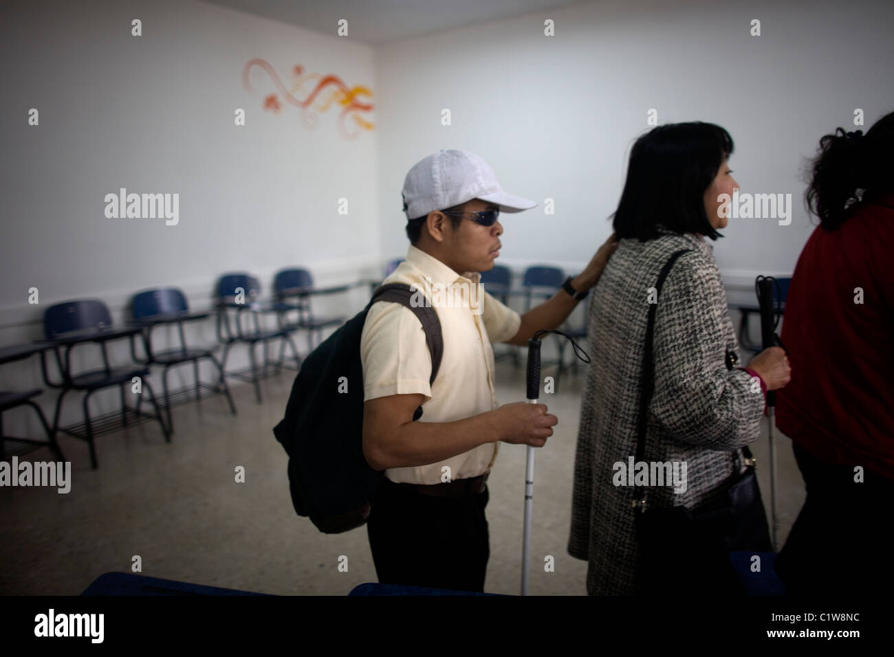 Blind students walk in line during a photography workshop for the blind and visually impaired in Mexico City Stock Photo