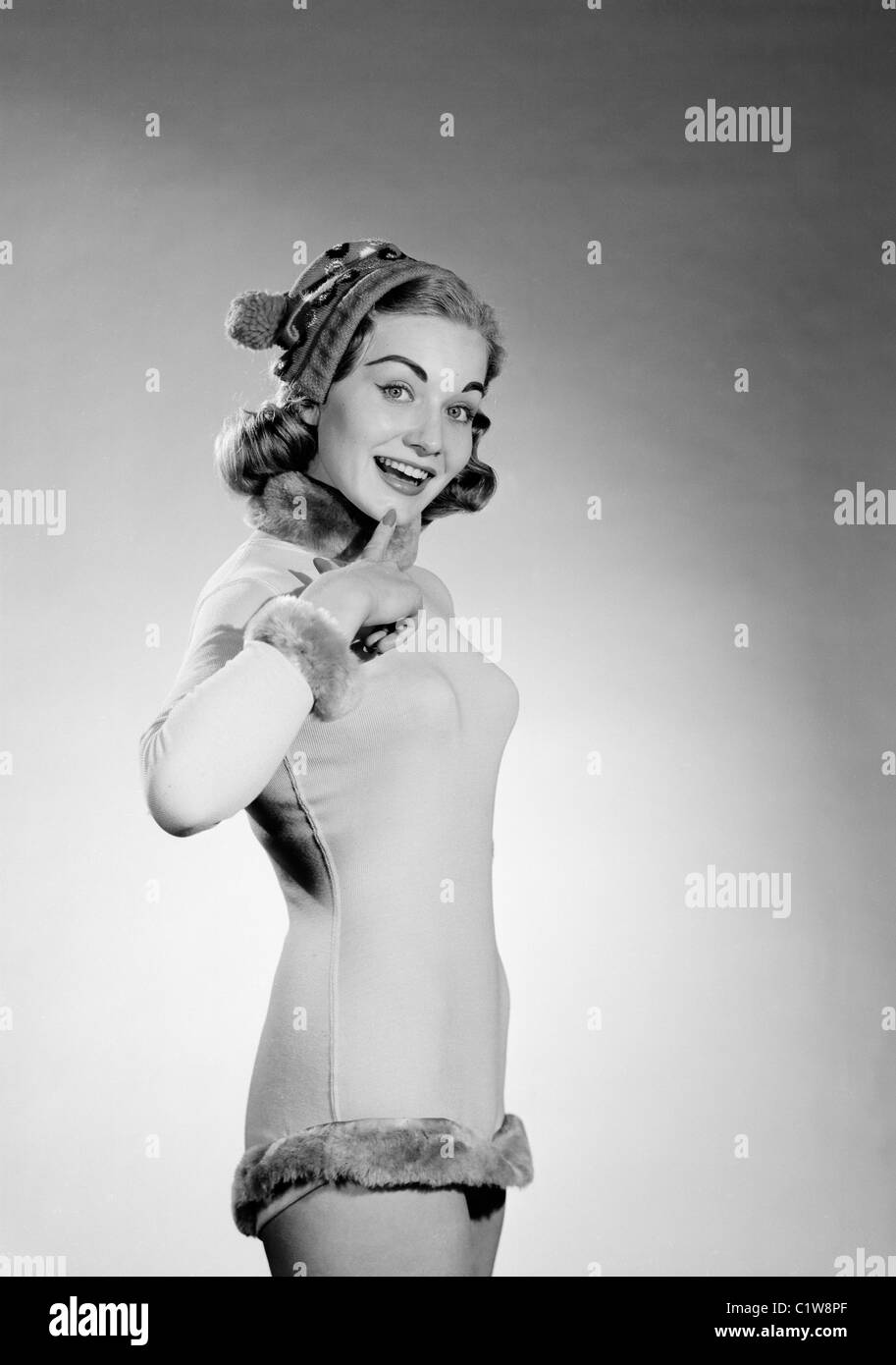 Portrait of young woman wearing costume and knit hat Stock Photo - Alamy