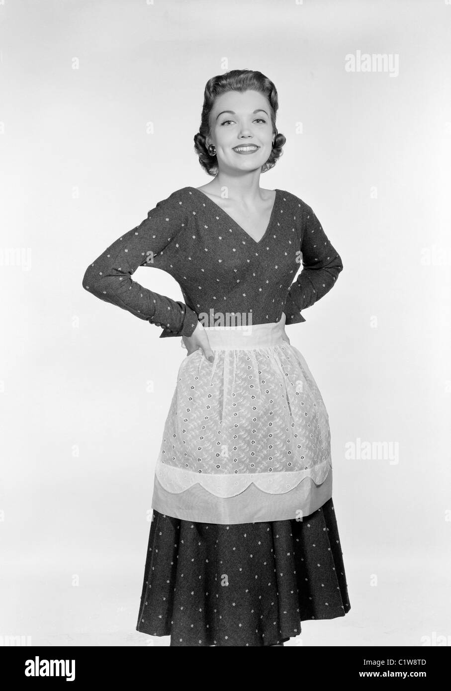 Portrait of young housewife wearing apron Stock Photo