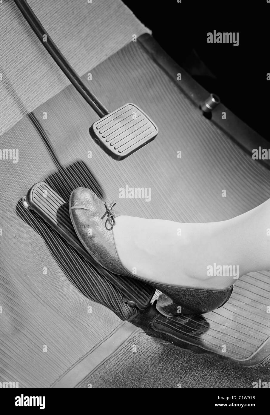 Womans foot on car brake pedal Stock Photo