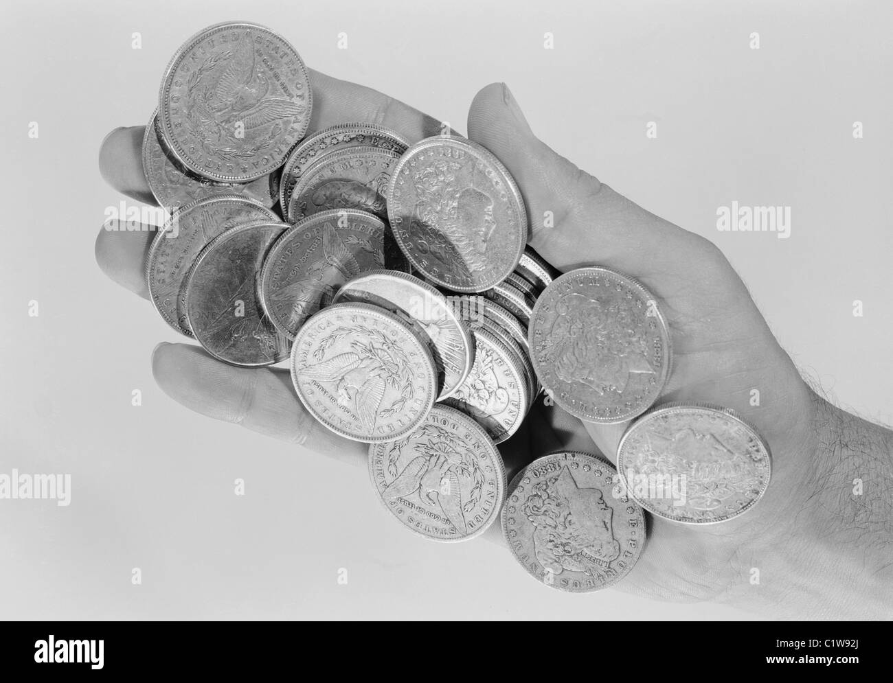 Hand holding old coins Stock Photo