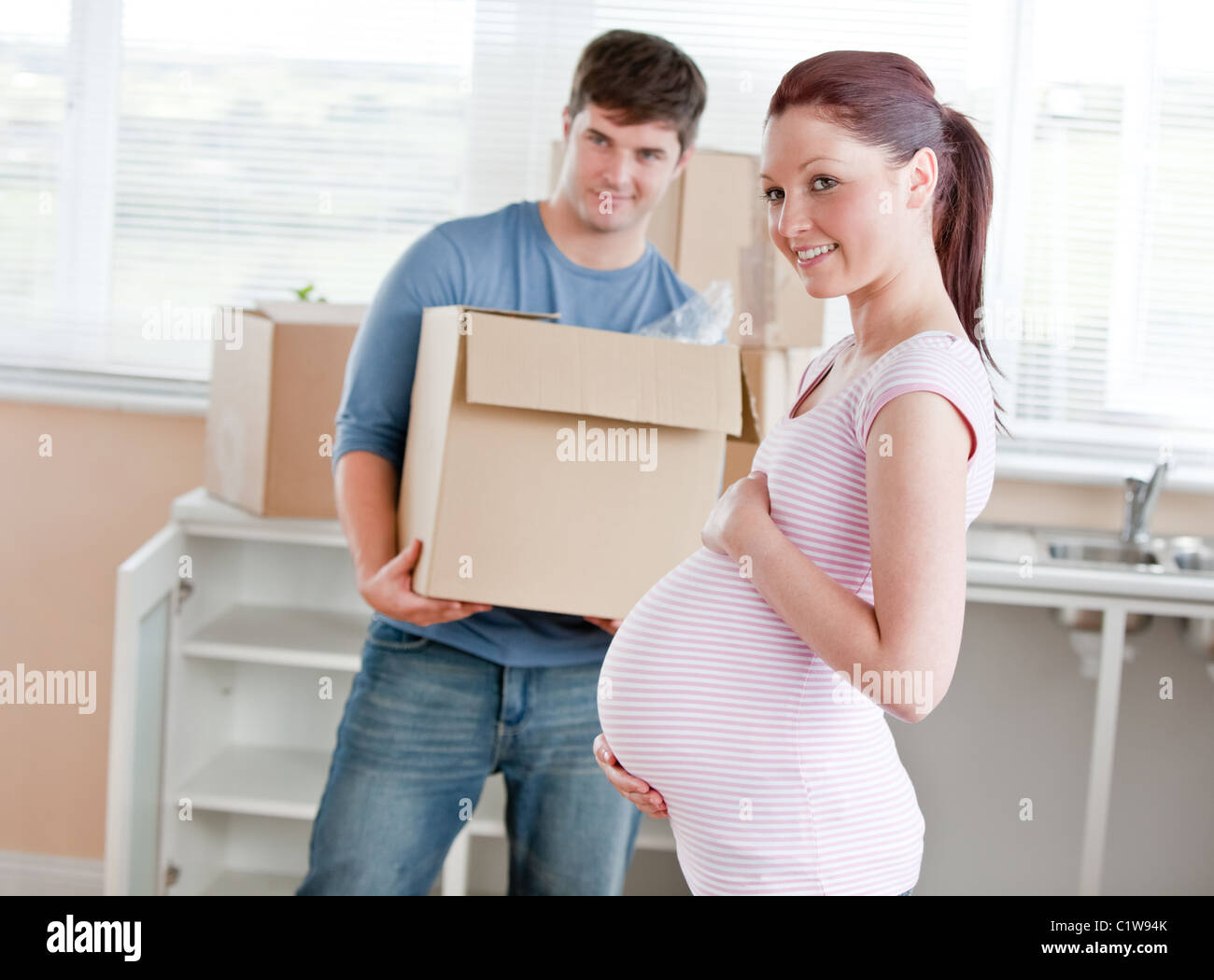 живот беременной. осложнения поднятия тяжестей. беременная женщина. беременные поднимают тяжести. беременная и тяжести.