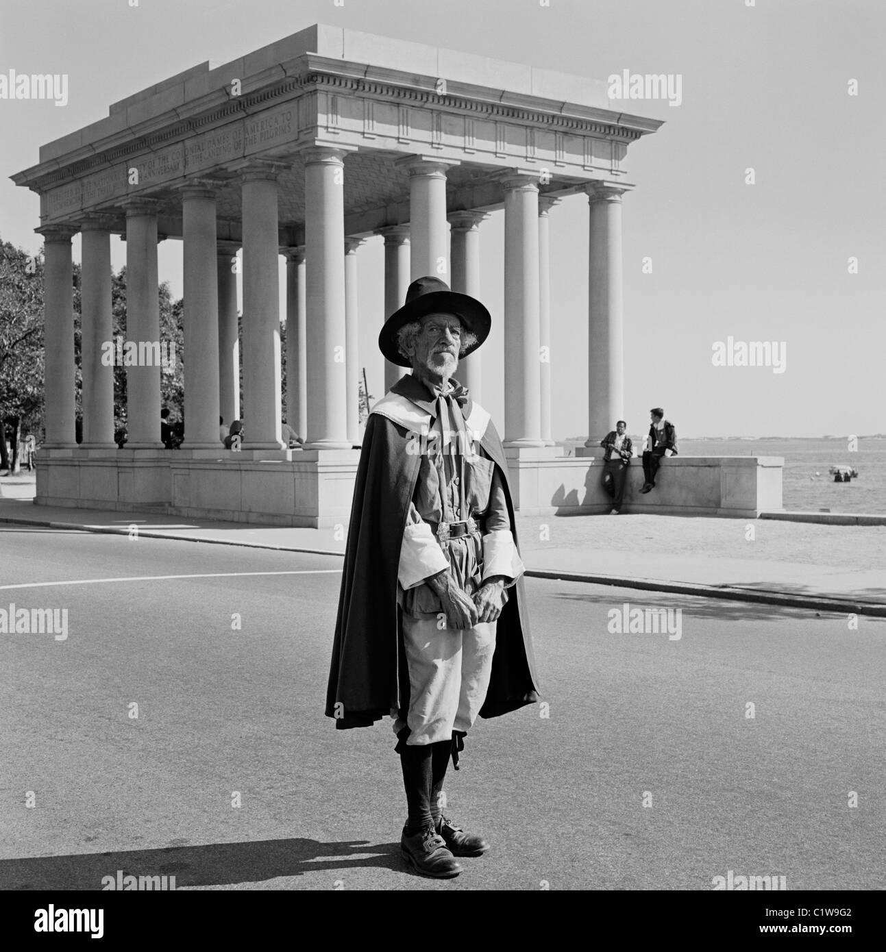USA, Massachusetts, Plymouth, Plymouth Rock showing attendant dressed as Pilgrim Father for atmosphere Stock Photo