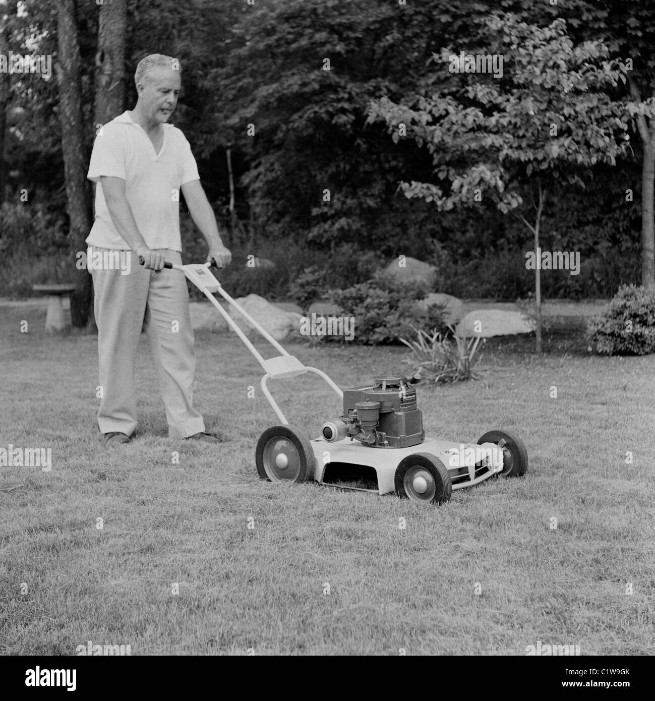 Man mowing the lawn Black and White Stock Photos & Images - Alamy