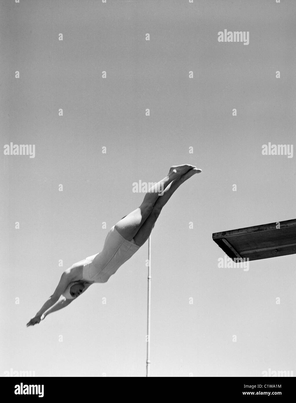 Swimmer jumping off diving board Stock Photo Alamy