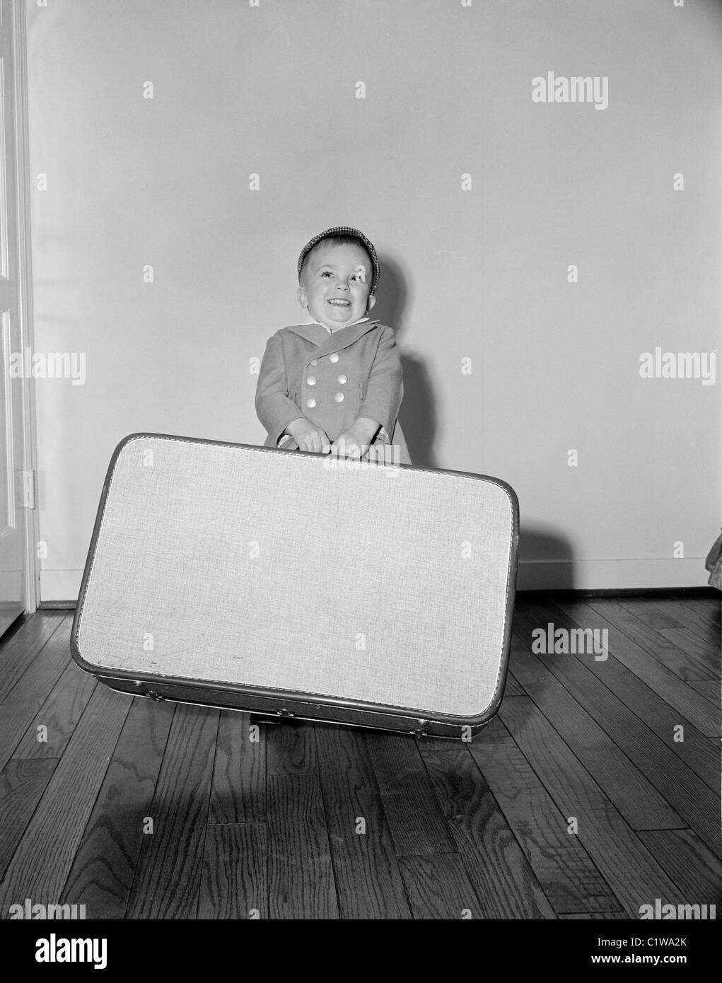 Boy holding large suitcase Stock Photo