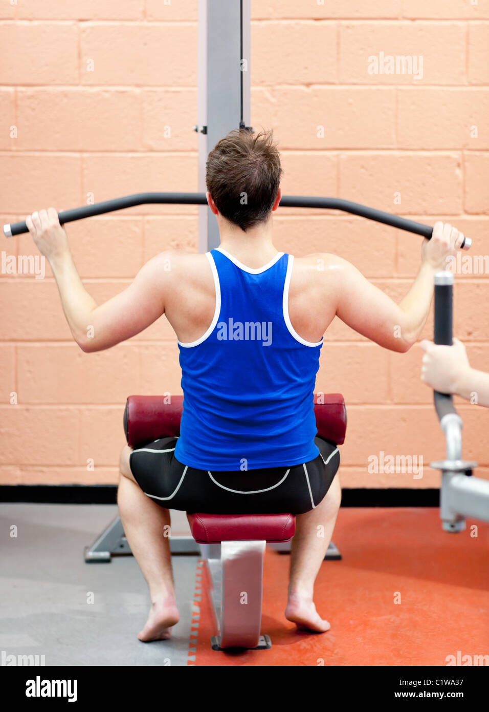 Assertive male athlete practicing body-building Stock Photo