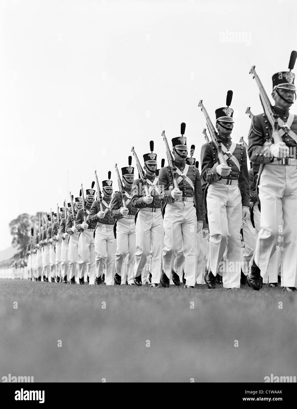 Soldierswearing military uniforms marching in parade formation Stock Photo