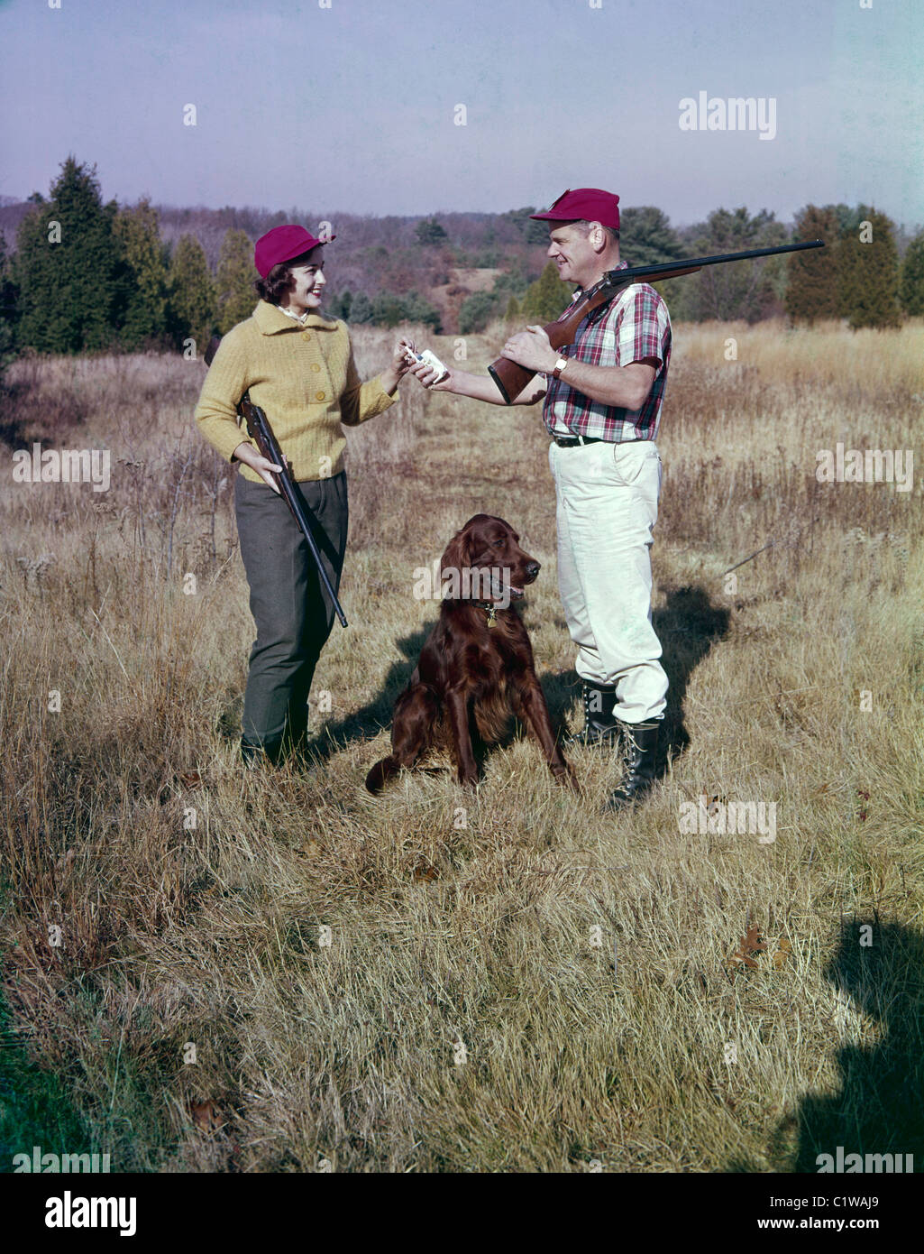 Mature couple and dog hunting Stock Photo