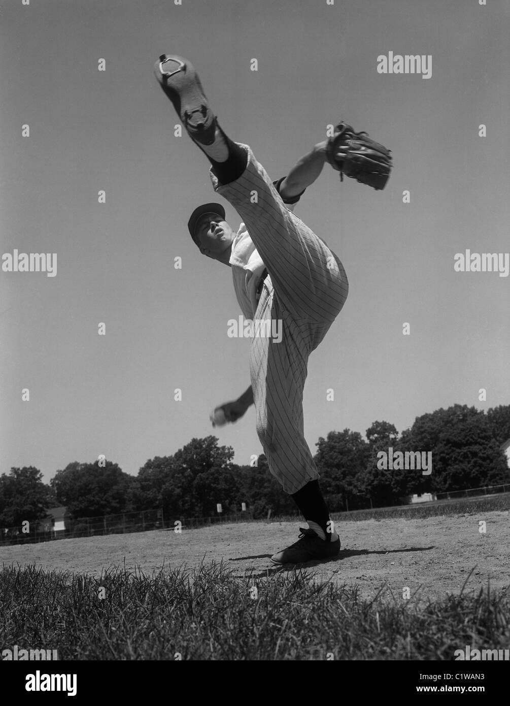 Baseball pitcher standing on one leg Stock Photo