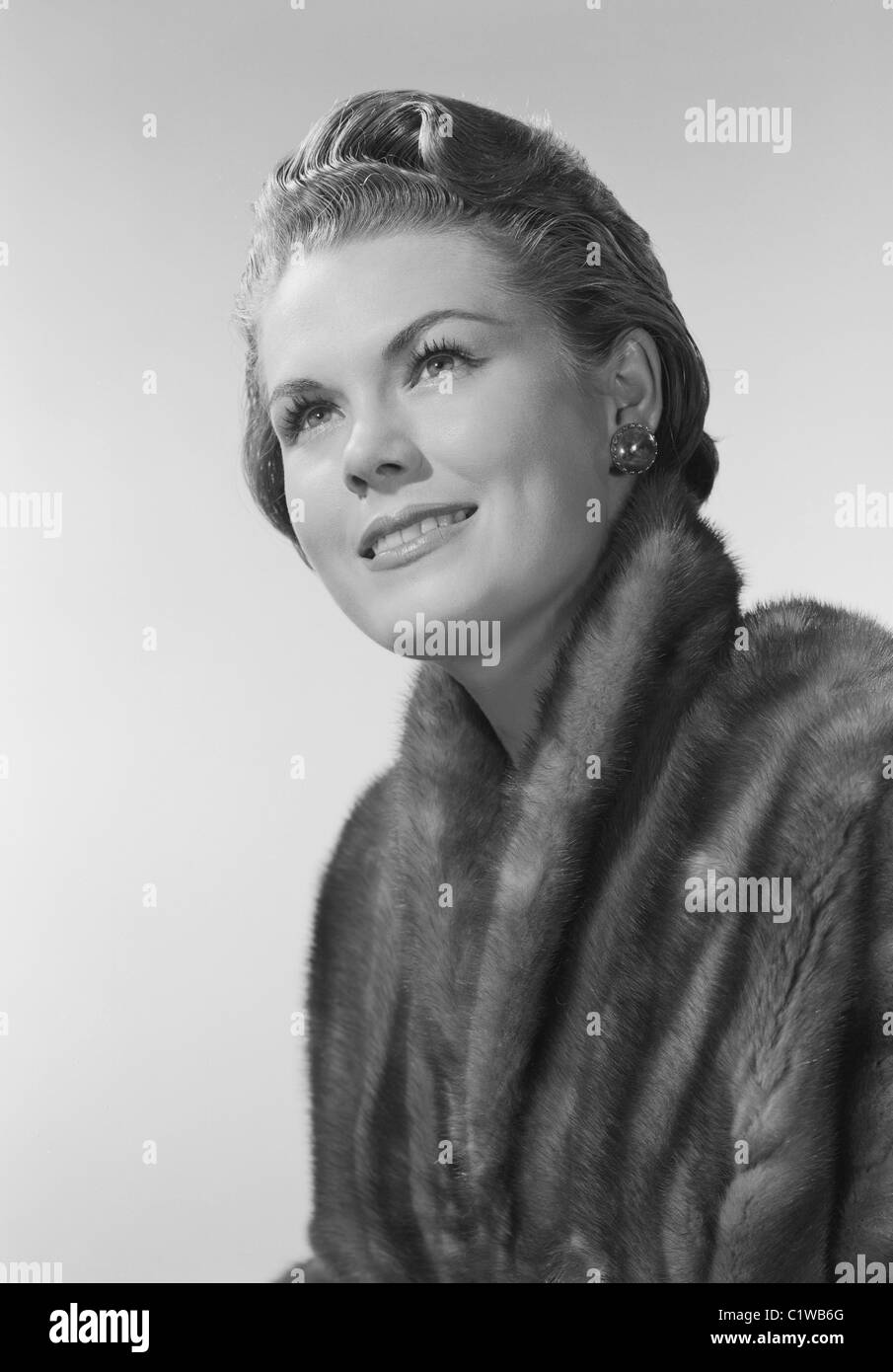 Studio portrait of mid adult woman smiling Stock Photo