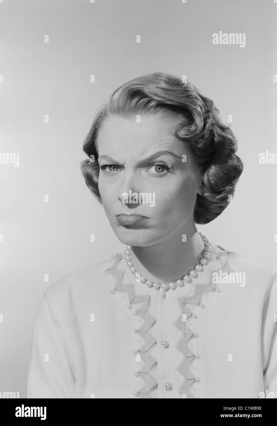 Studio portrait of young woman with facial expression Stock Photo Alamy