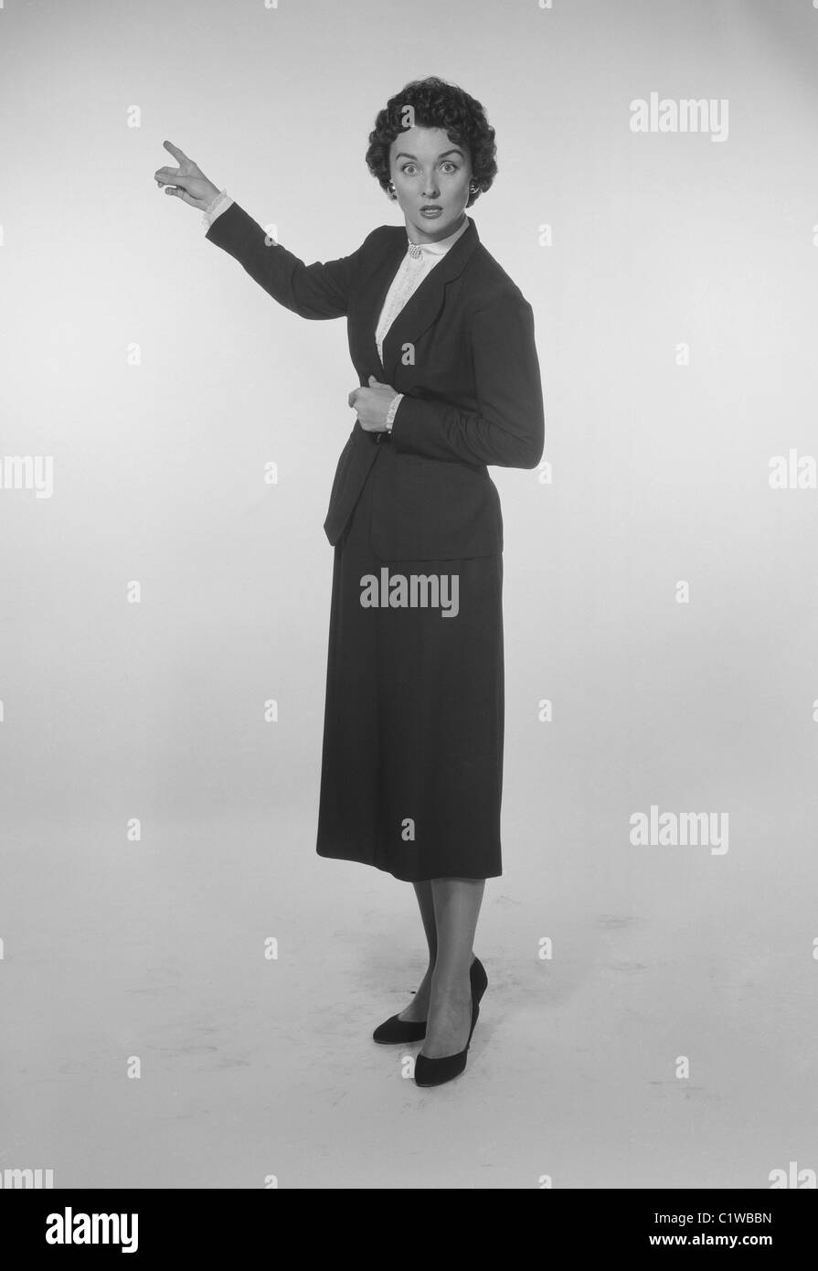Studio Portrait of a mid adult woman gesturing Stock Photo