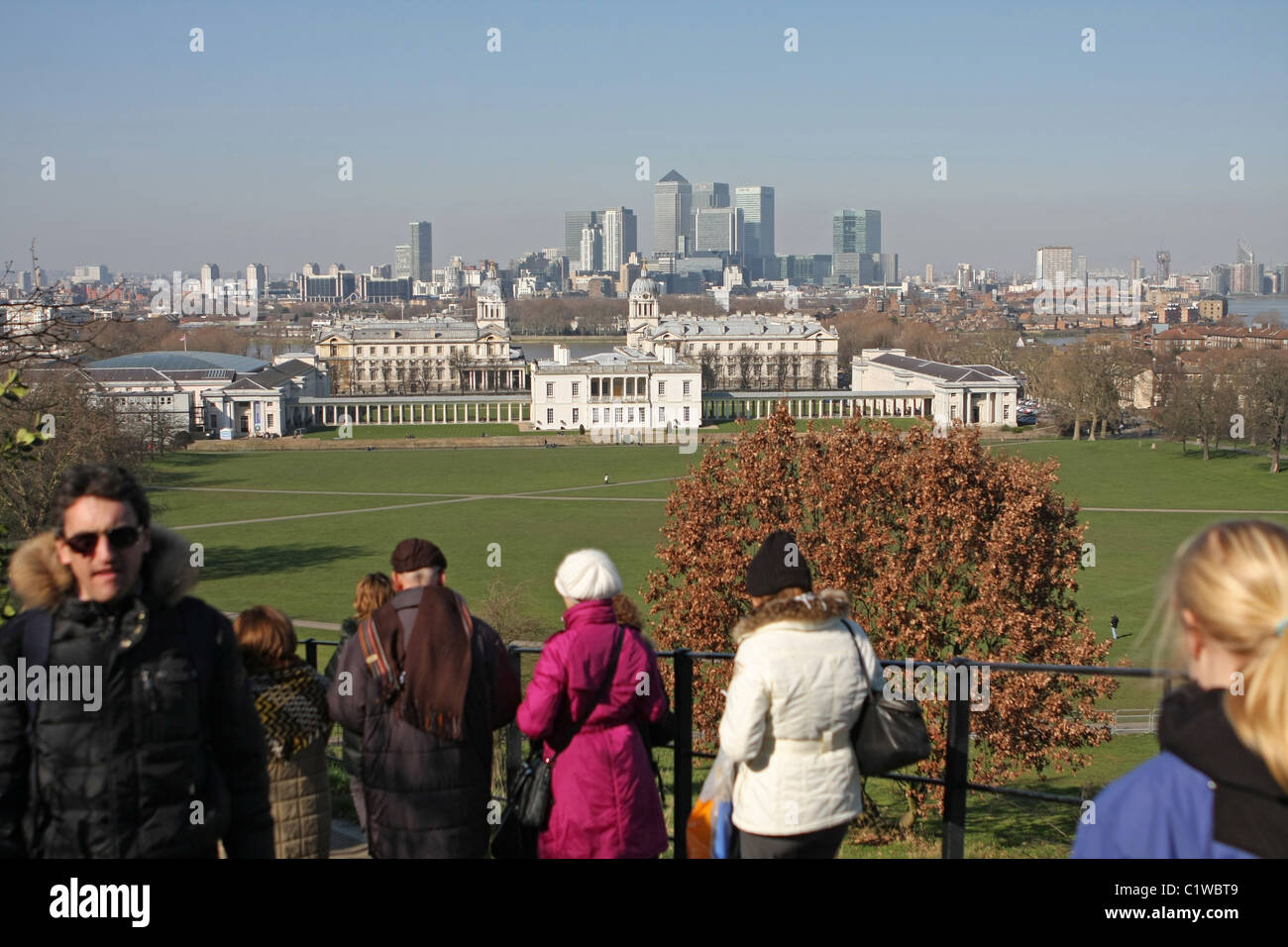 A view across part of London, from Greenwich Park, with people walking to and from the Royal Observatory in the foreground Stock Photo