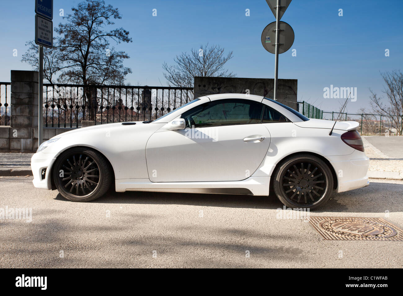 White Mercedes-Benz SLK sports car parked in the street Stock Photo