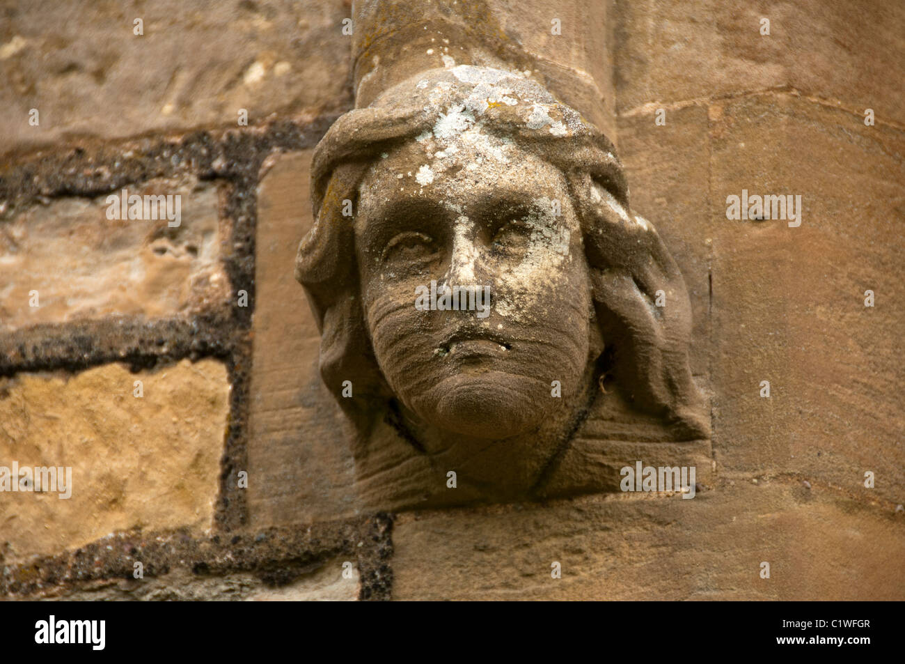 Carved stone face at the church of St Michael the Archangel, Laxton, Nottinghamshire, England, UK Stock Photo