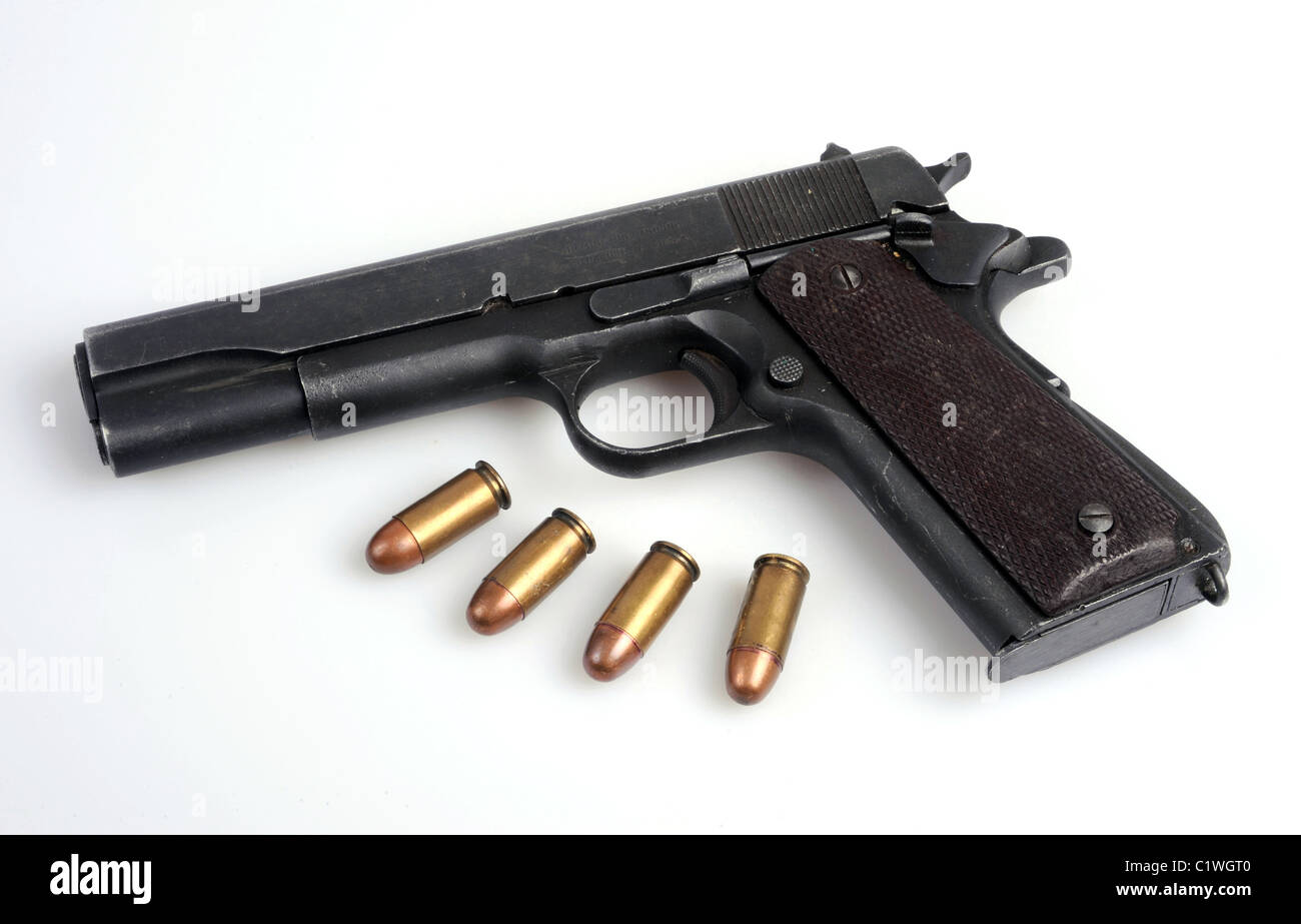 The famous Colt45 automatic pistol and ammo. Stock Photo