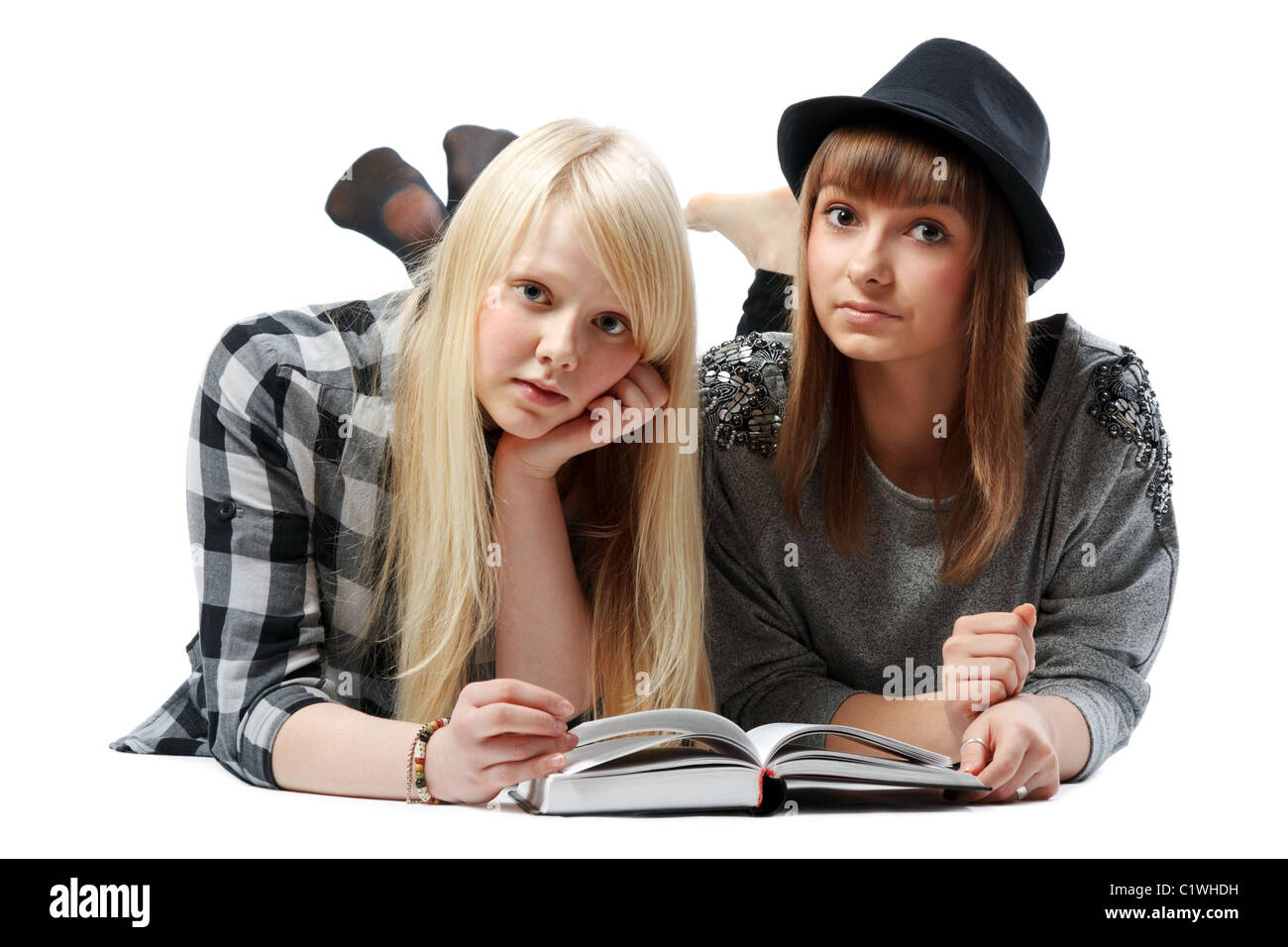 Two girls lies and read books on white background Stock Photo - Alamy