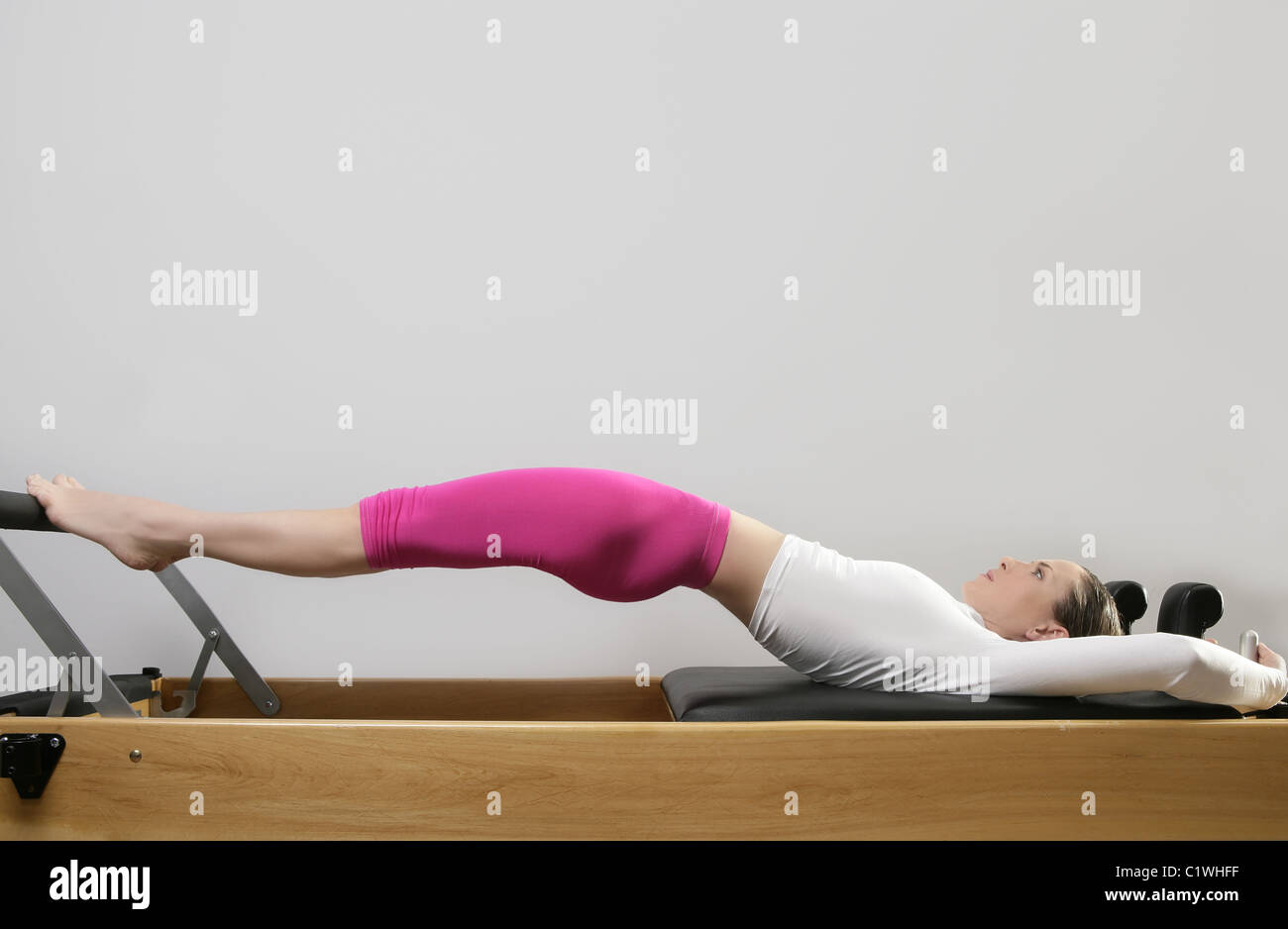 gym woman pilates stretching sport in reformer bed instructor girl Stock Photo