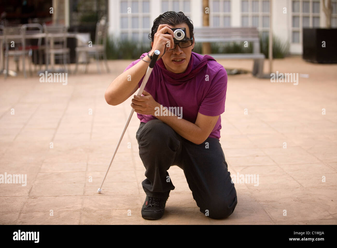 A visually impaired photographer takes pictures during a photography