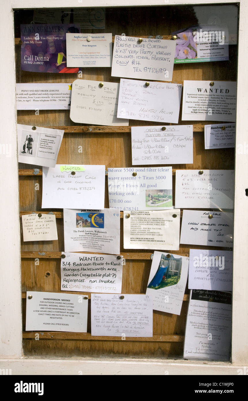 Community notice board with postcard adverts Stock Photo Alamy