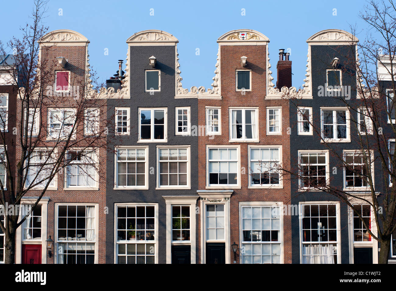 Traditional historic Dutch gable houses beside canal in Amsterdam The Netherlands Stock Photo