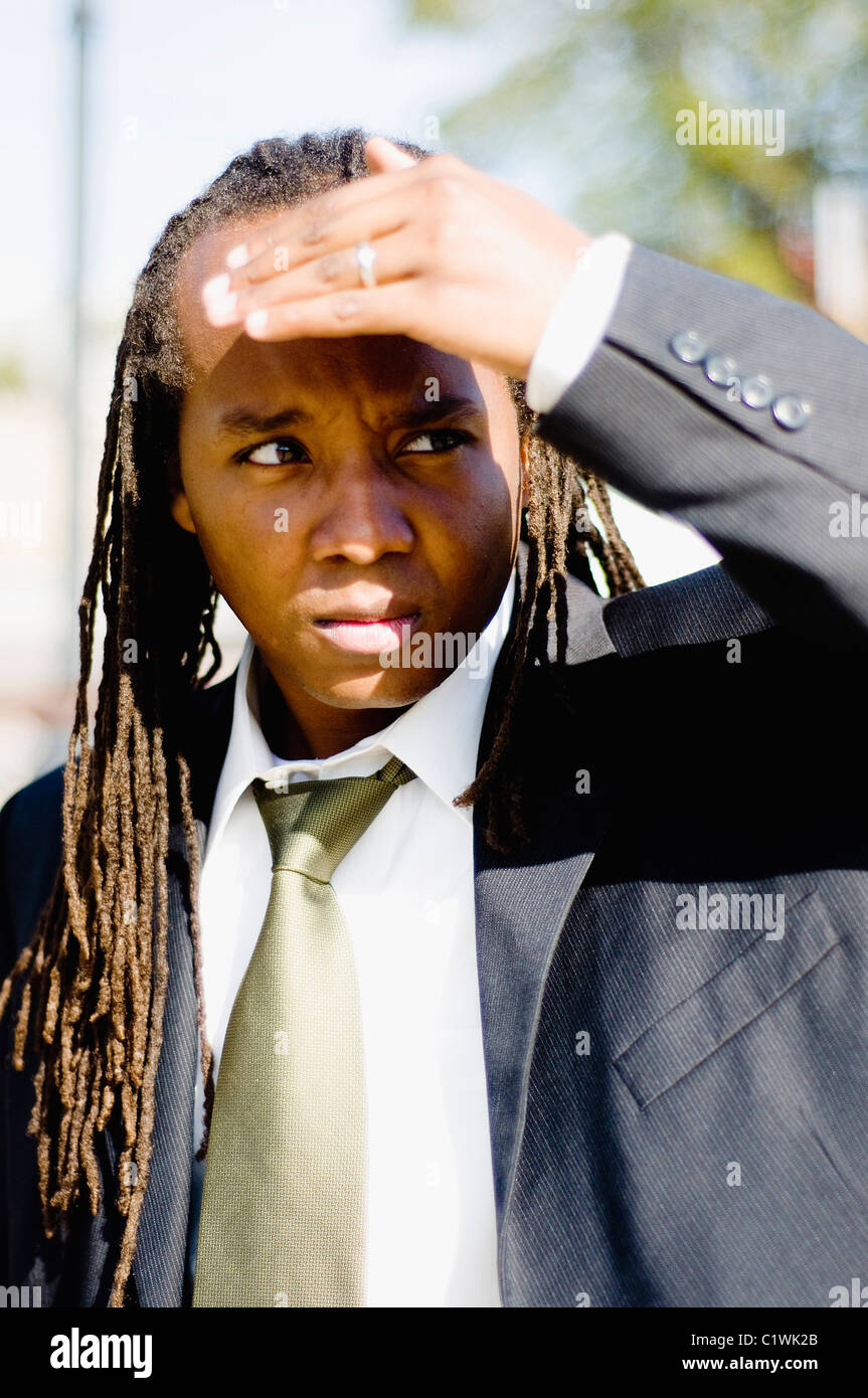 Close-up of a businessman with shielding eyes Stock Photo - Alamy