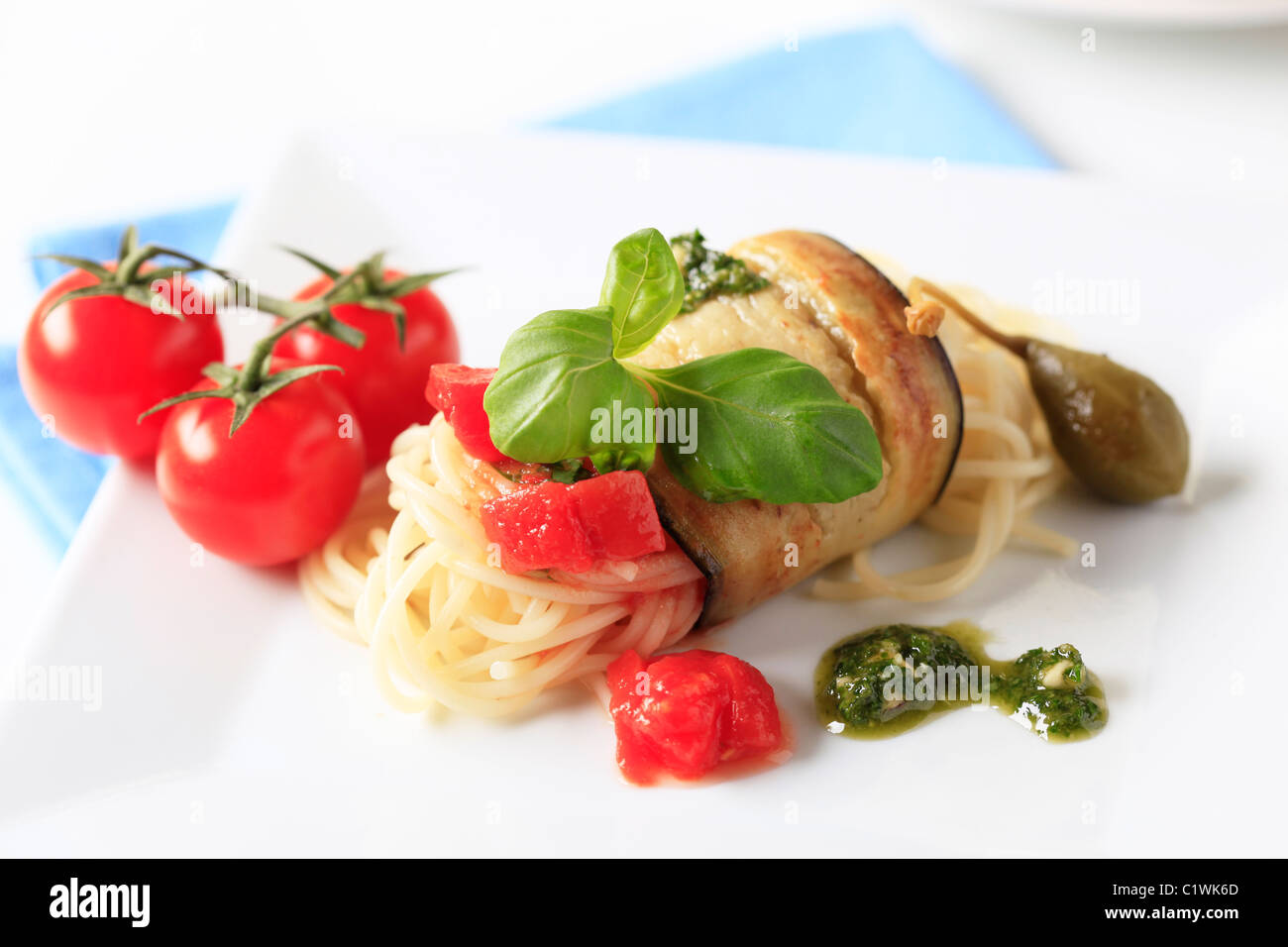 Spaghetti wrapped in a slice of grilled aubergine Stock Photo