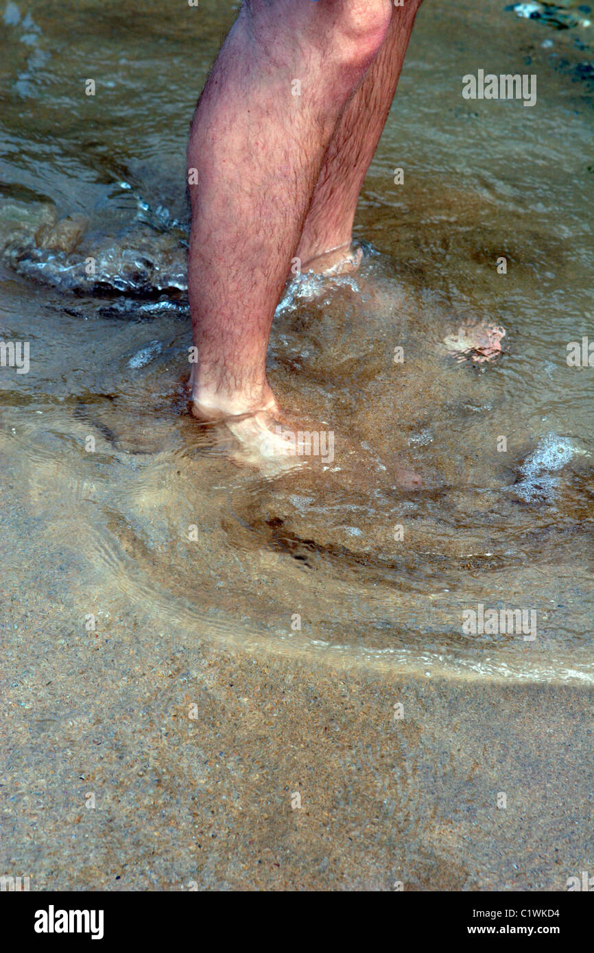 Man paddling in sea water at beach Stock Photo