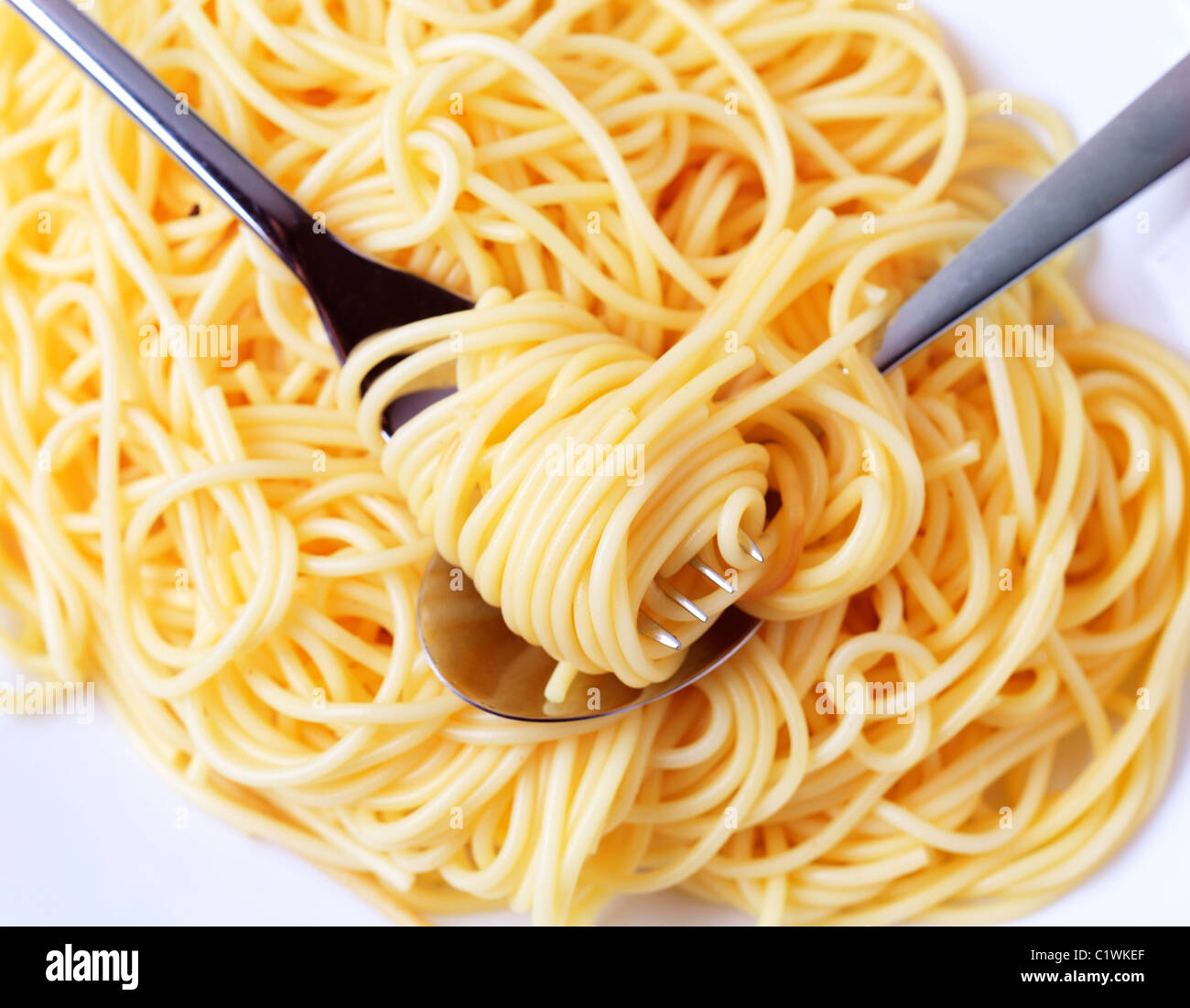 Spaghetti twirled around a fork - overhead Stock Photo