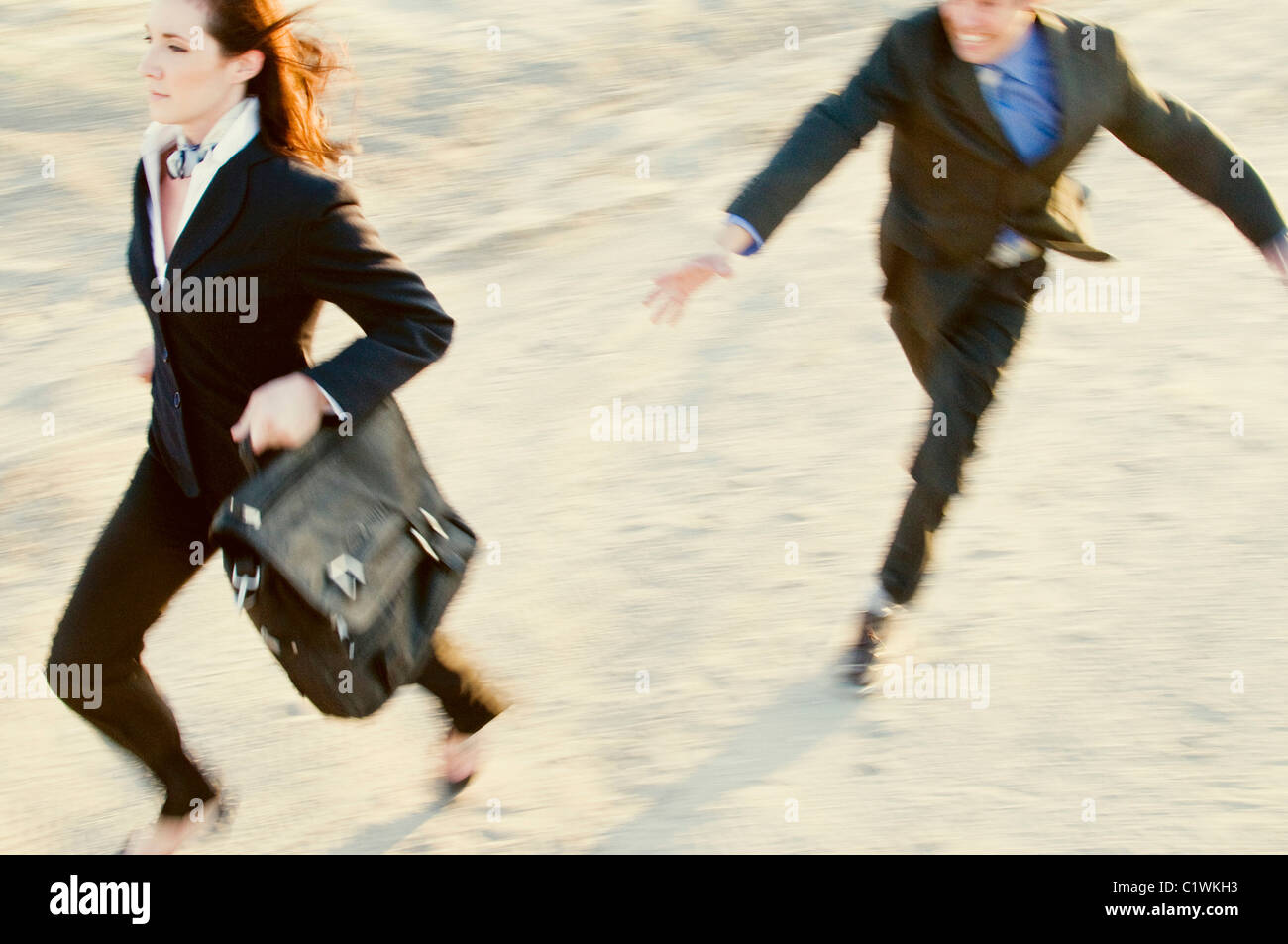 Businessman chasing a businesswoman Stock Photo - Alamy