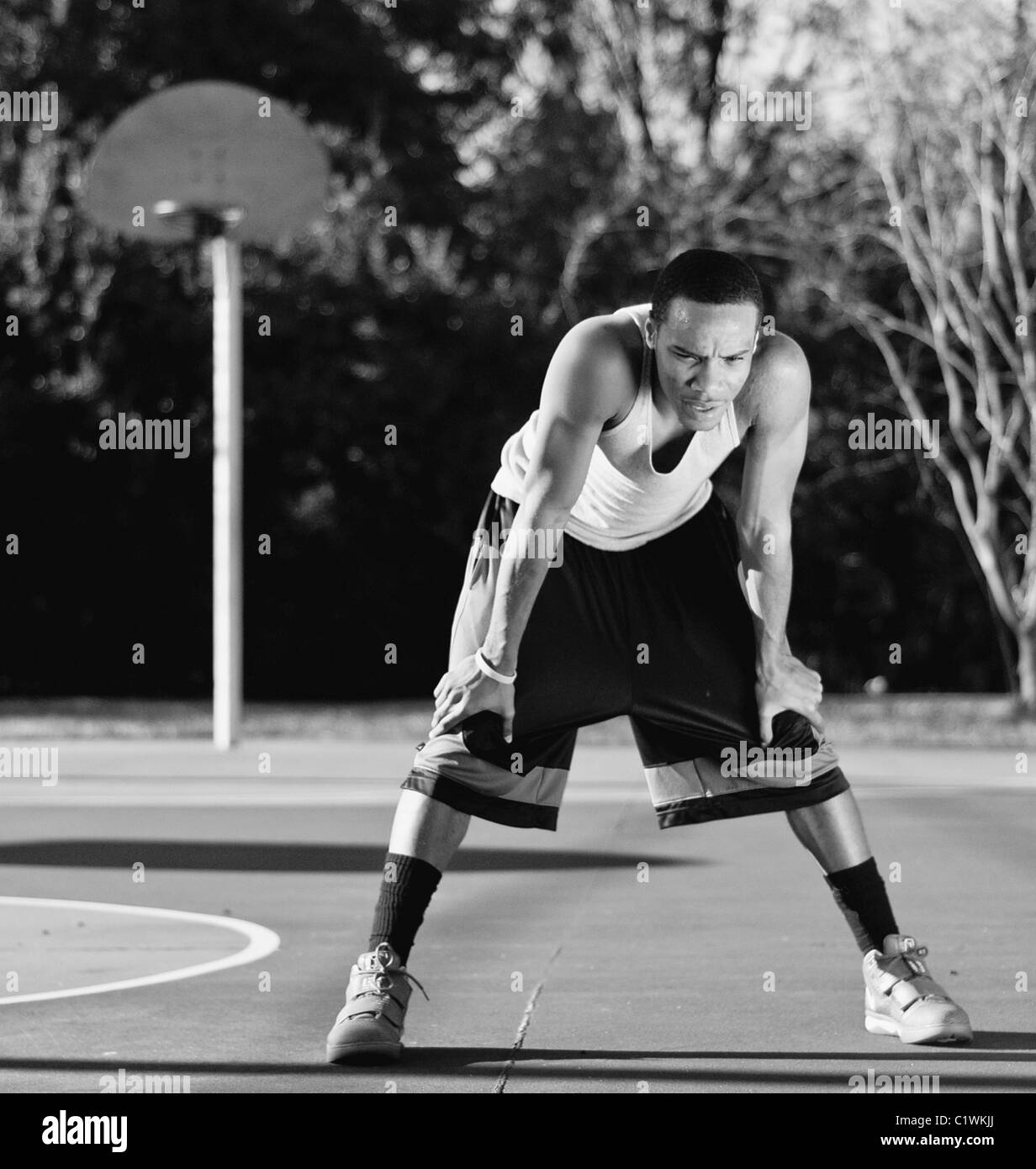 Basketball player looking tired in a court Stock Photo Alamy