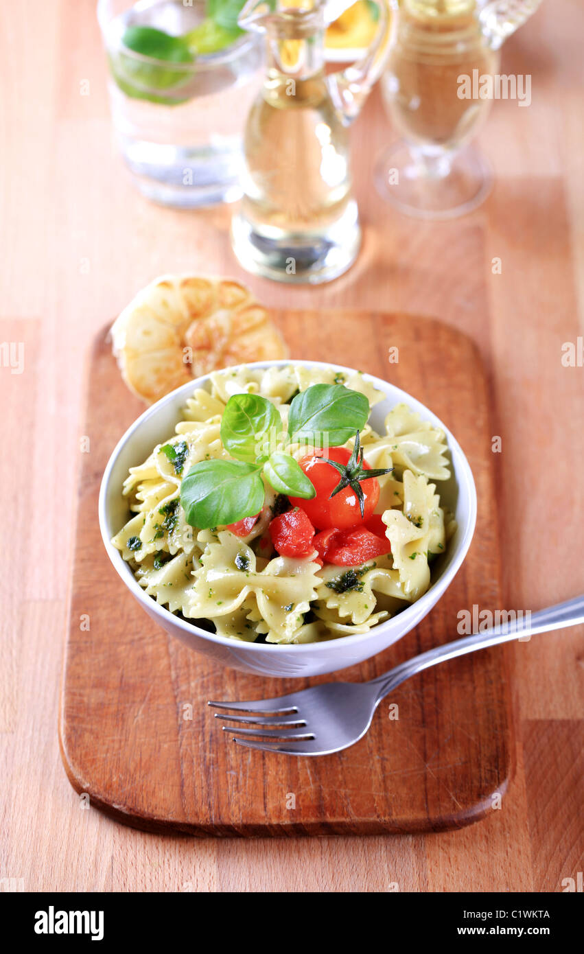 Bow tie pasta with pesto and tomato Stock Photo Alamy