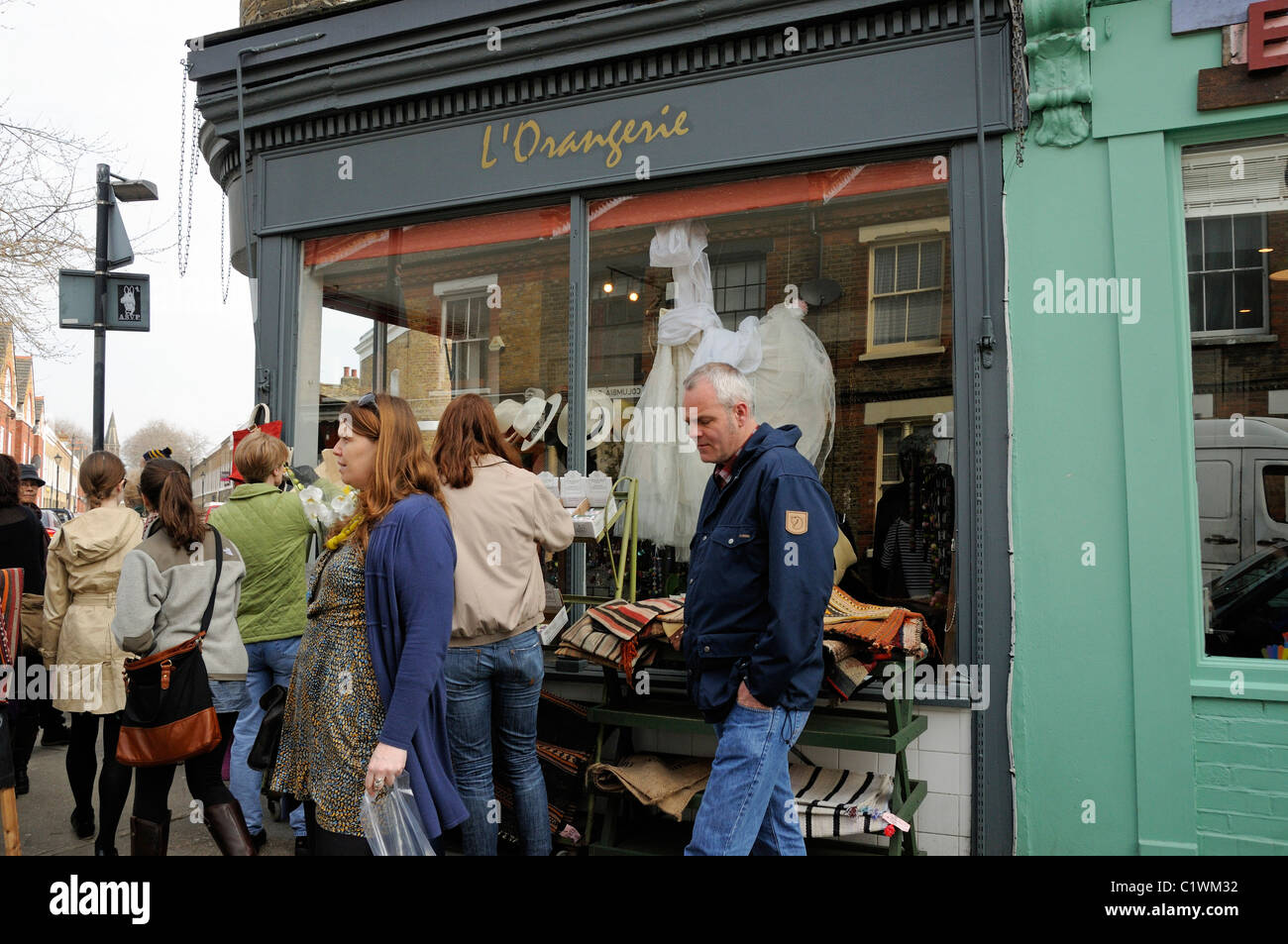 People in front of L'Orangerie shop in a busy Columbia Road Flower Market Tower Hamlets East London England UK Stock Photo