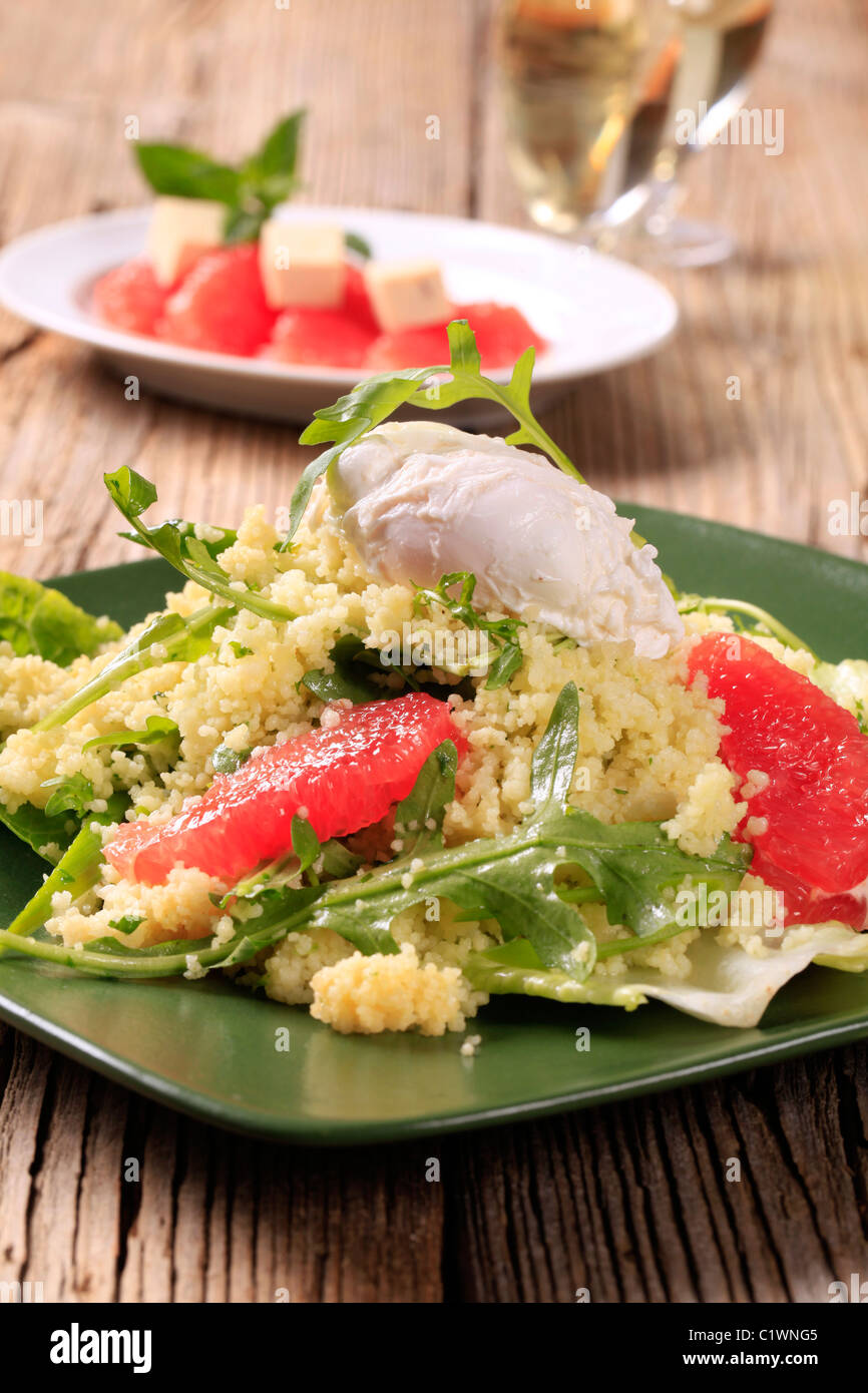 Couscous with red orange and rocket, poached egg on top Stock Photo Alamy