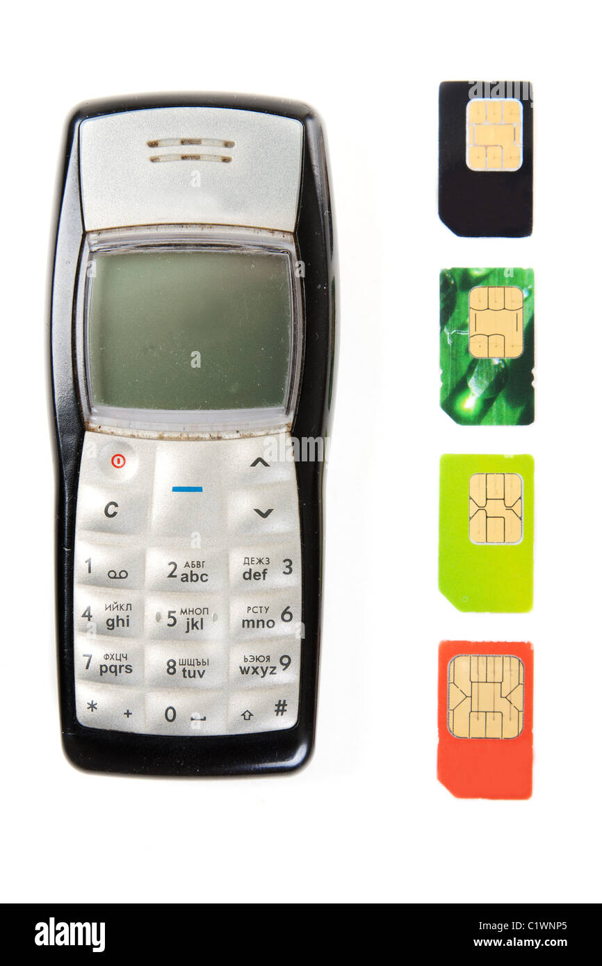 Old mobile phones and four SIM cards Stock Photo