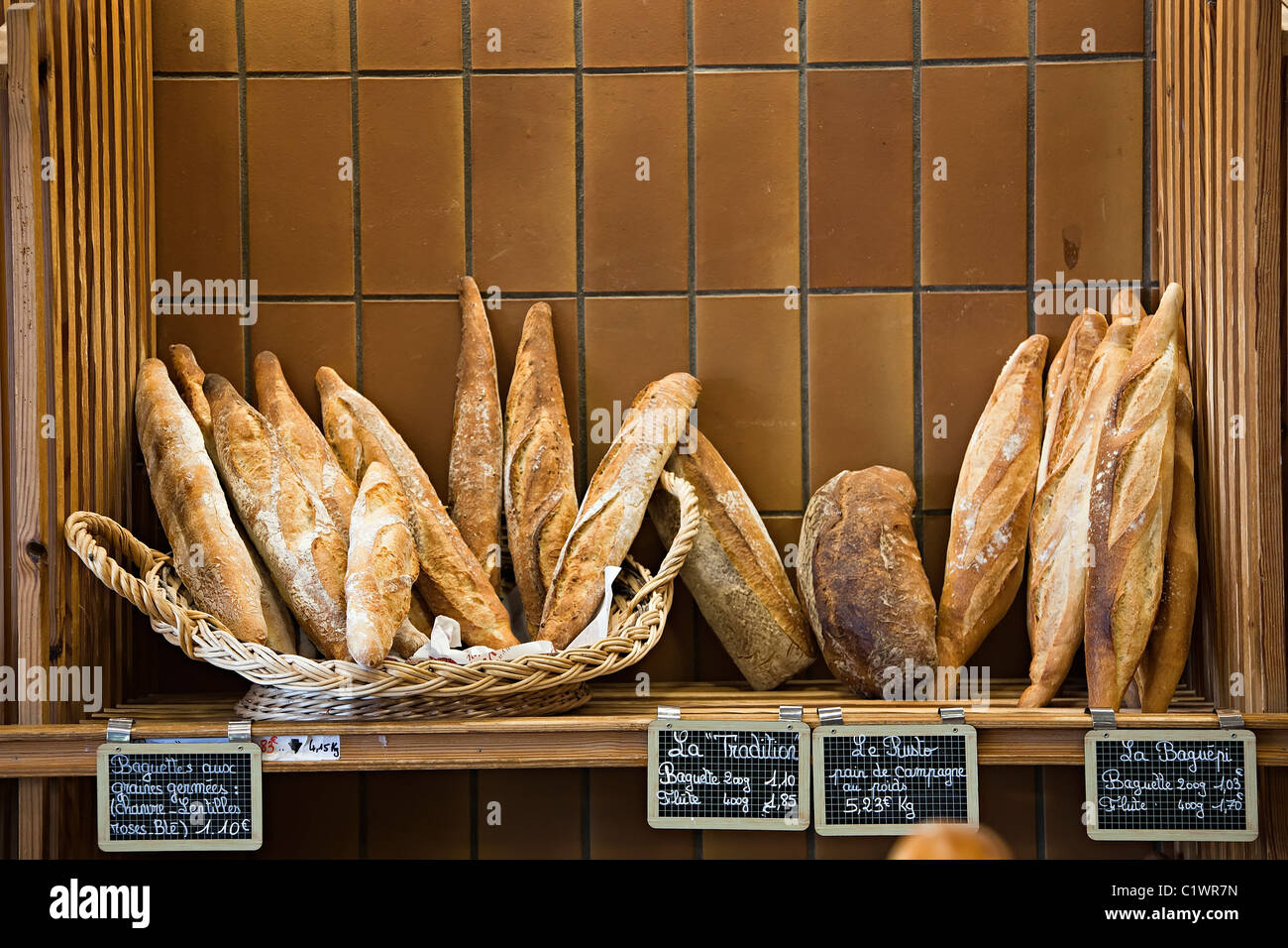 Fresh bread loaves in bakery with price labels Ariege France Stock Photo
