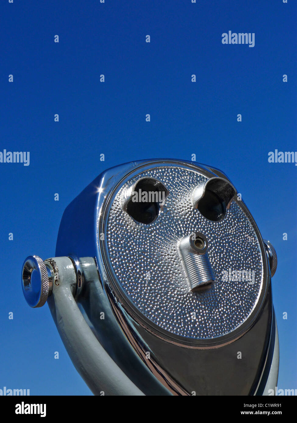 Sightseeing tourist viewer against blue sky. Stock Photo
