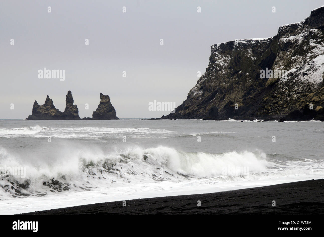 Black sand beach, the Reynisdrangar sea stacks and the Reynnisfjall ...