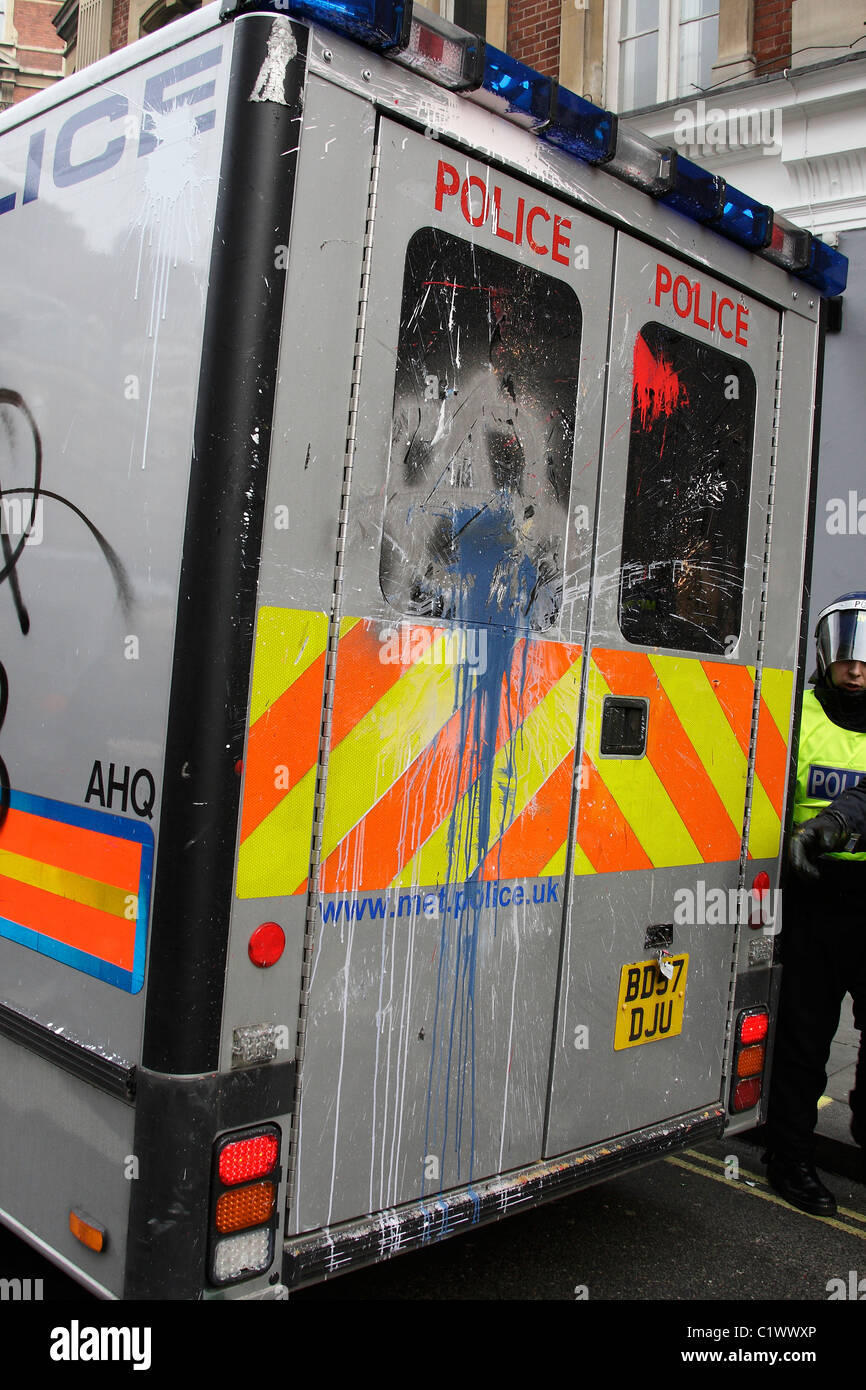 Police riot van damaged by anarchists in London Stock Photo