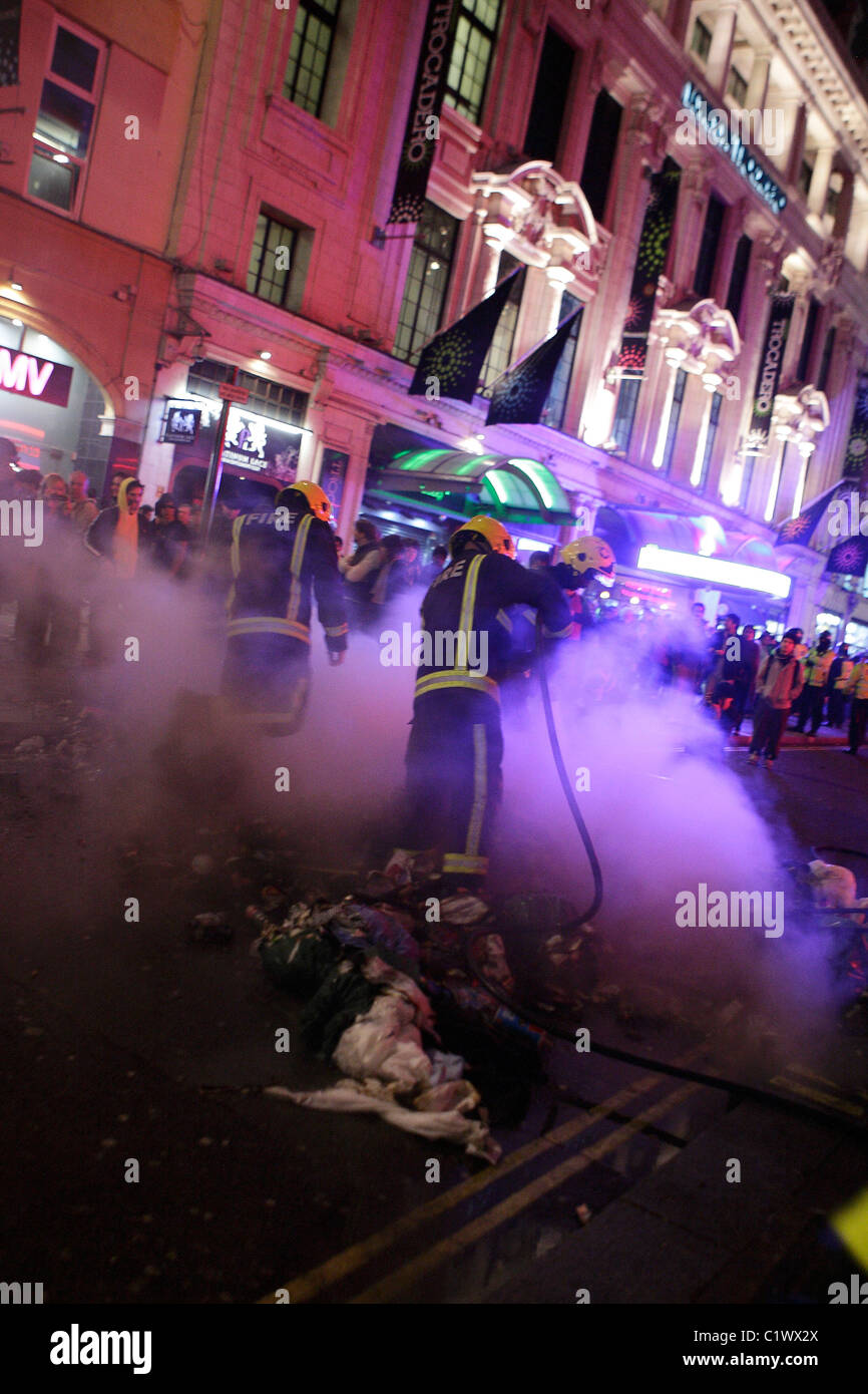 Fire crews protected by riot police in London Stock Photo - Alamy