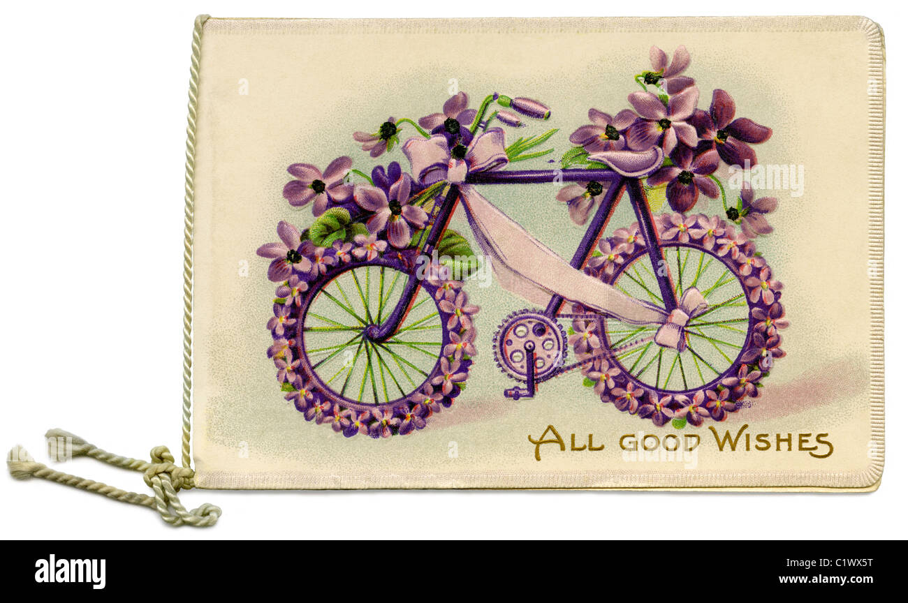 Unusual Victorian Christmas card c. 1890, featuring an embossed illustration of a bicycle decorated with flowers and a ribbon Stock Photo
