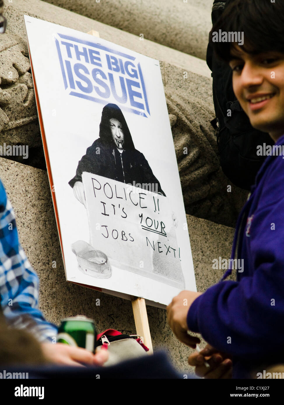 A protester puts the finishing touches to his placard during the TUC public spending cuts protest on 26th March 2011 in London Stock Photo