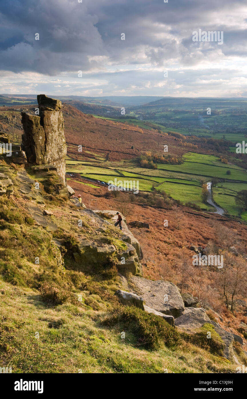 Gritstone rock formations at Curbar Edge, Peak District, Derbyshire, with rock climbers, November 2010. Stock Photo