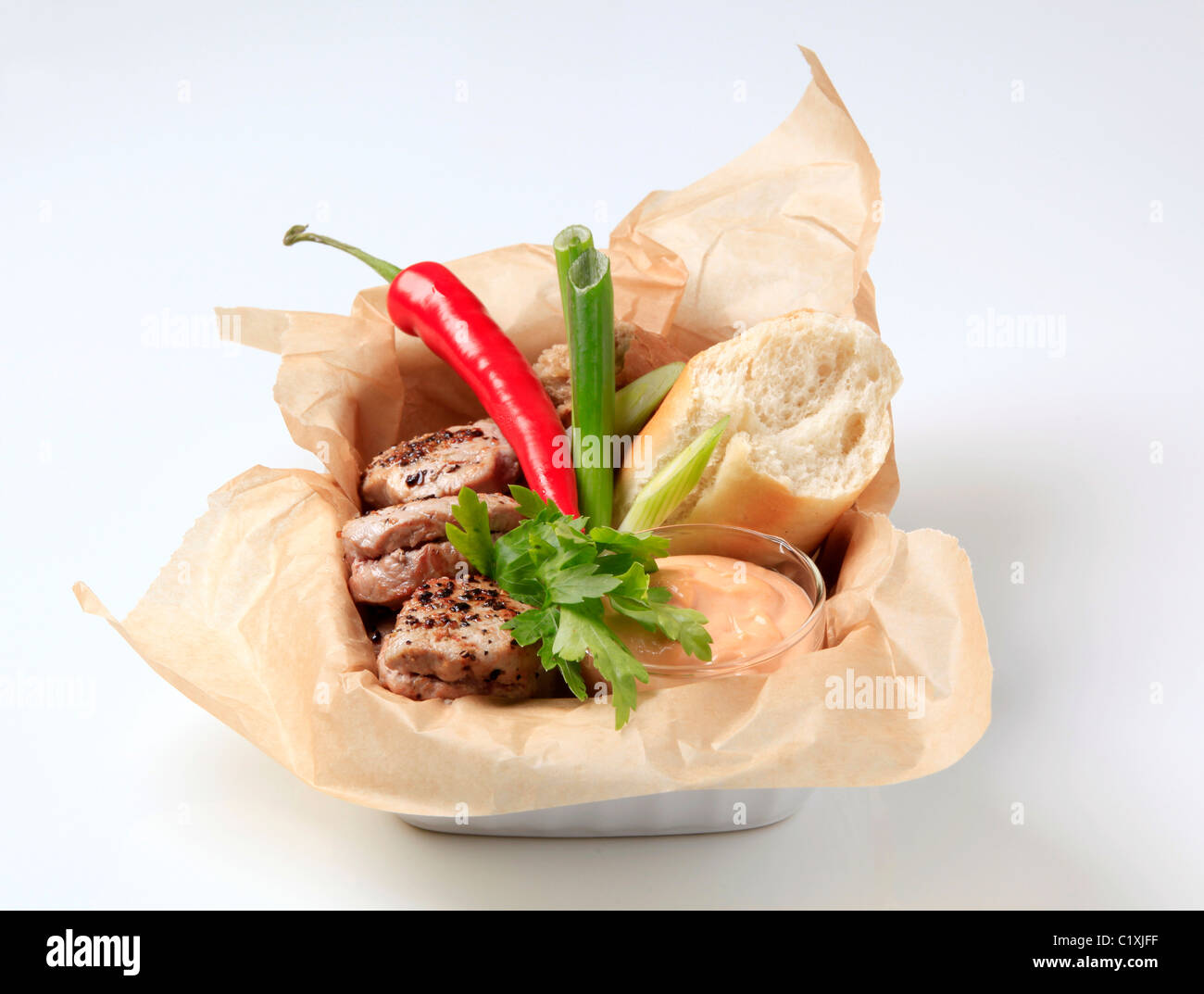 Pork filet mignons with bread and dip - studio Stock Photo