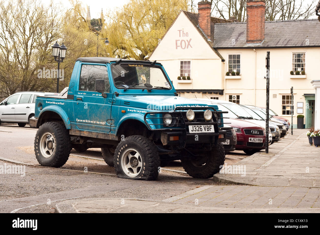 Jeep with a flat tyre in Bury St Edmunds Stock Photo